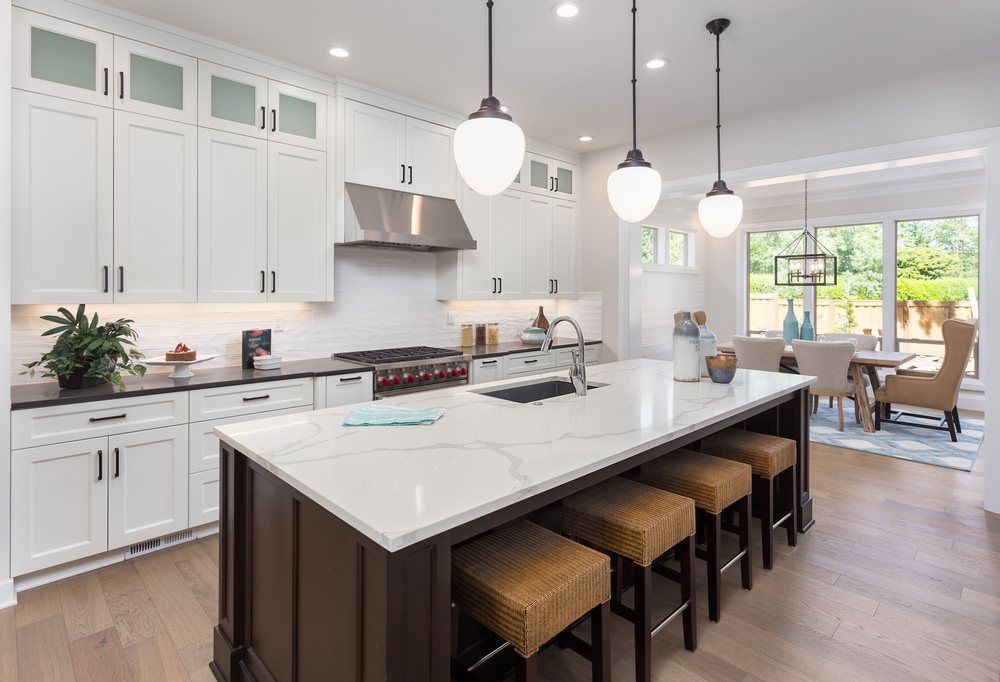 Updated kitchen with white cabinets and large island
