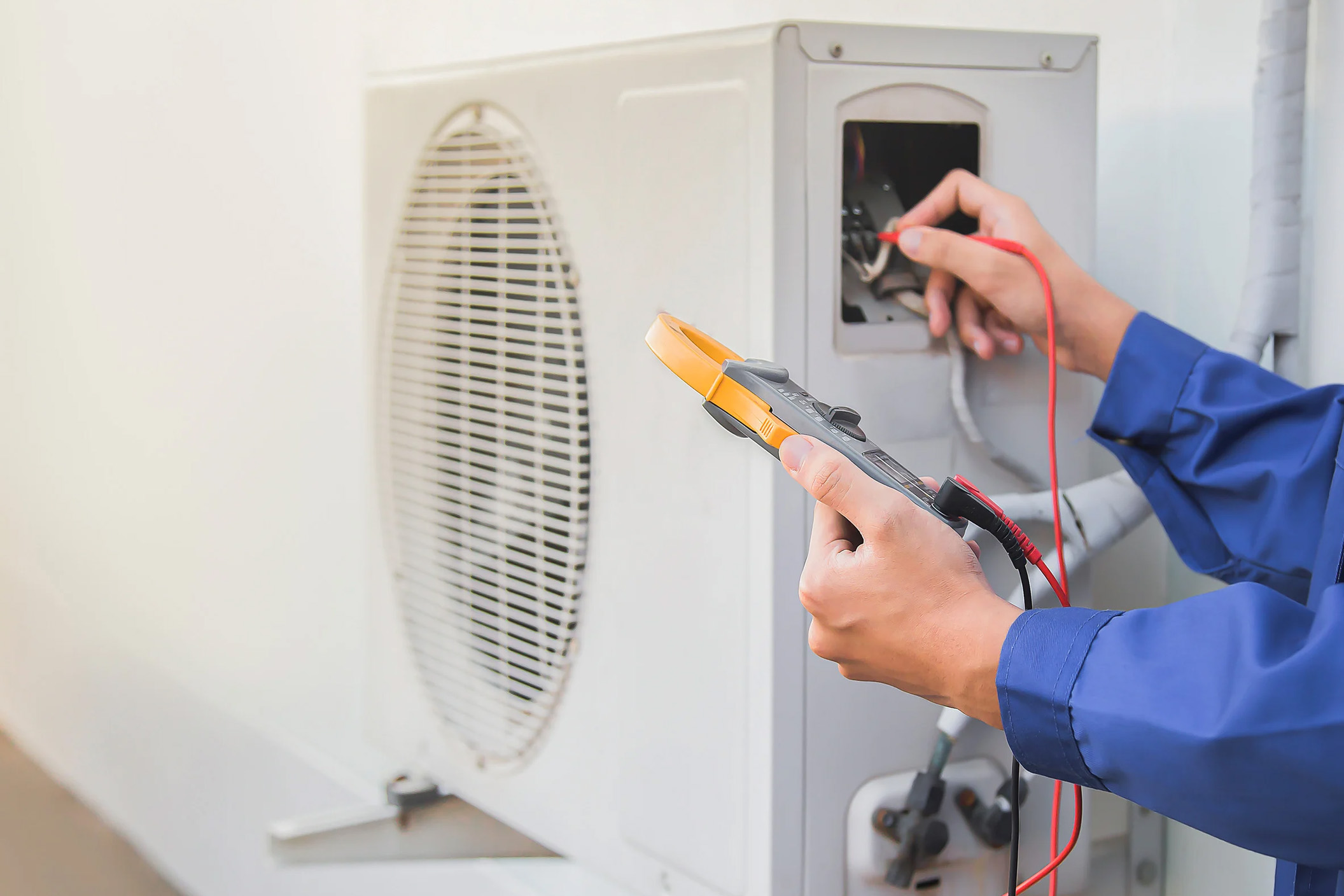 Technician servicing a home system covered by a home warranty