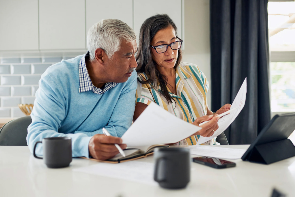 Home buyers reviewing seller disclosure documents with a real estate agent